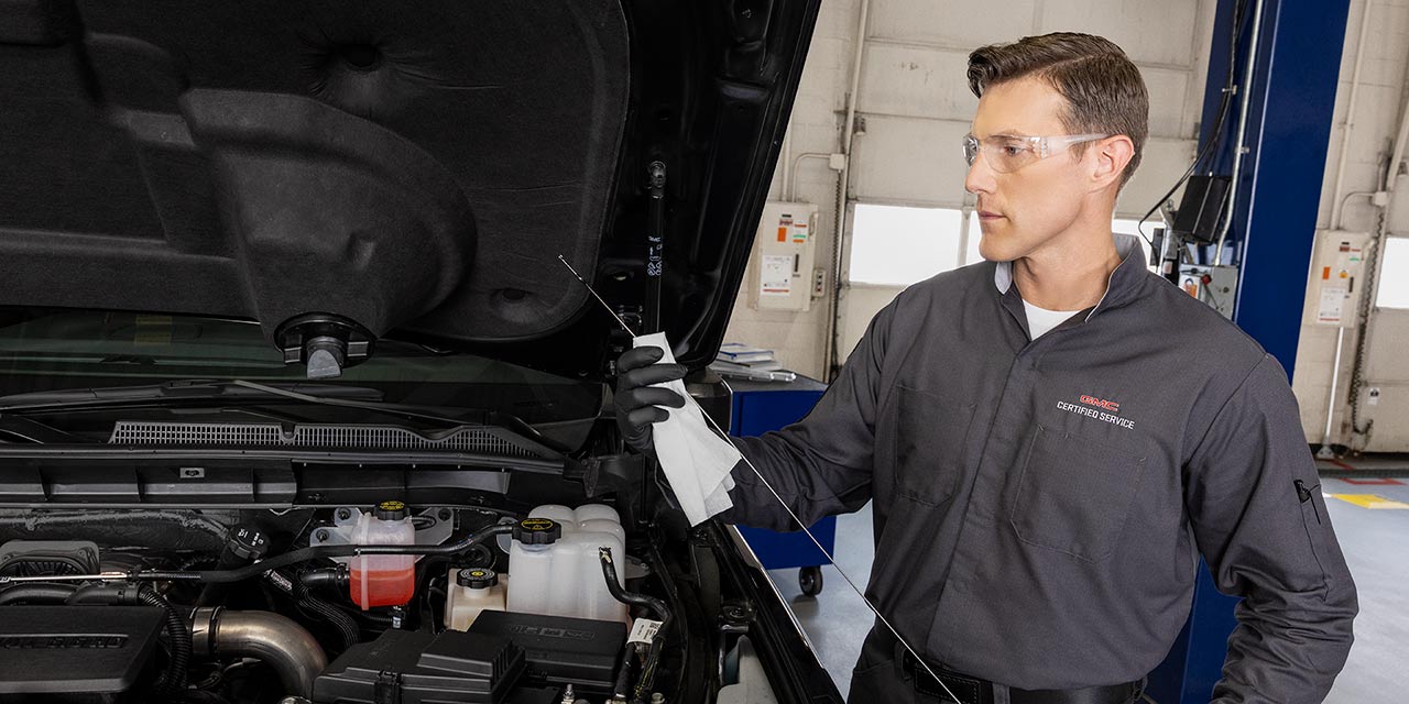 A Mechanic Servicing a GMC Vehicle in an Auto Shop