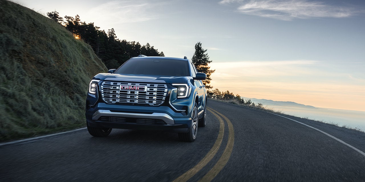 The GMC Terrain Small SUV Driving Down a Winding Road Along the Coast Line