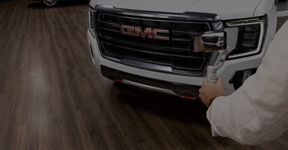 Man With a Tablet Displaying the GMC Hummer EV