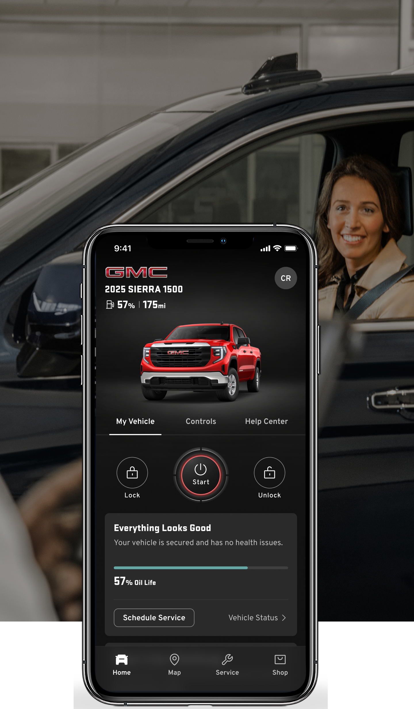 A Woman in a Vehicle with a Phone Displayed on Top of the Image with the myGMC Mobile App.