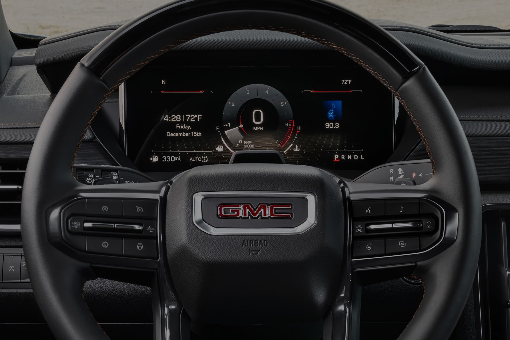 A Front View of the Steering Wheel and Dashboard of a GMC Vehicle.