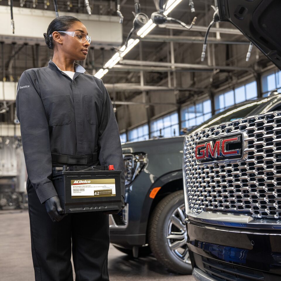 A Woman Using the MyGMC Mobile App at a Dealership