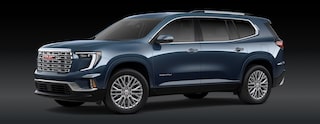 A Dark Blue GMC Acadia Denali SUV Is Parked From a Front Three-Quarters Angle Against a Dark Background