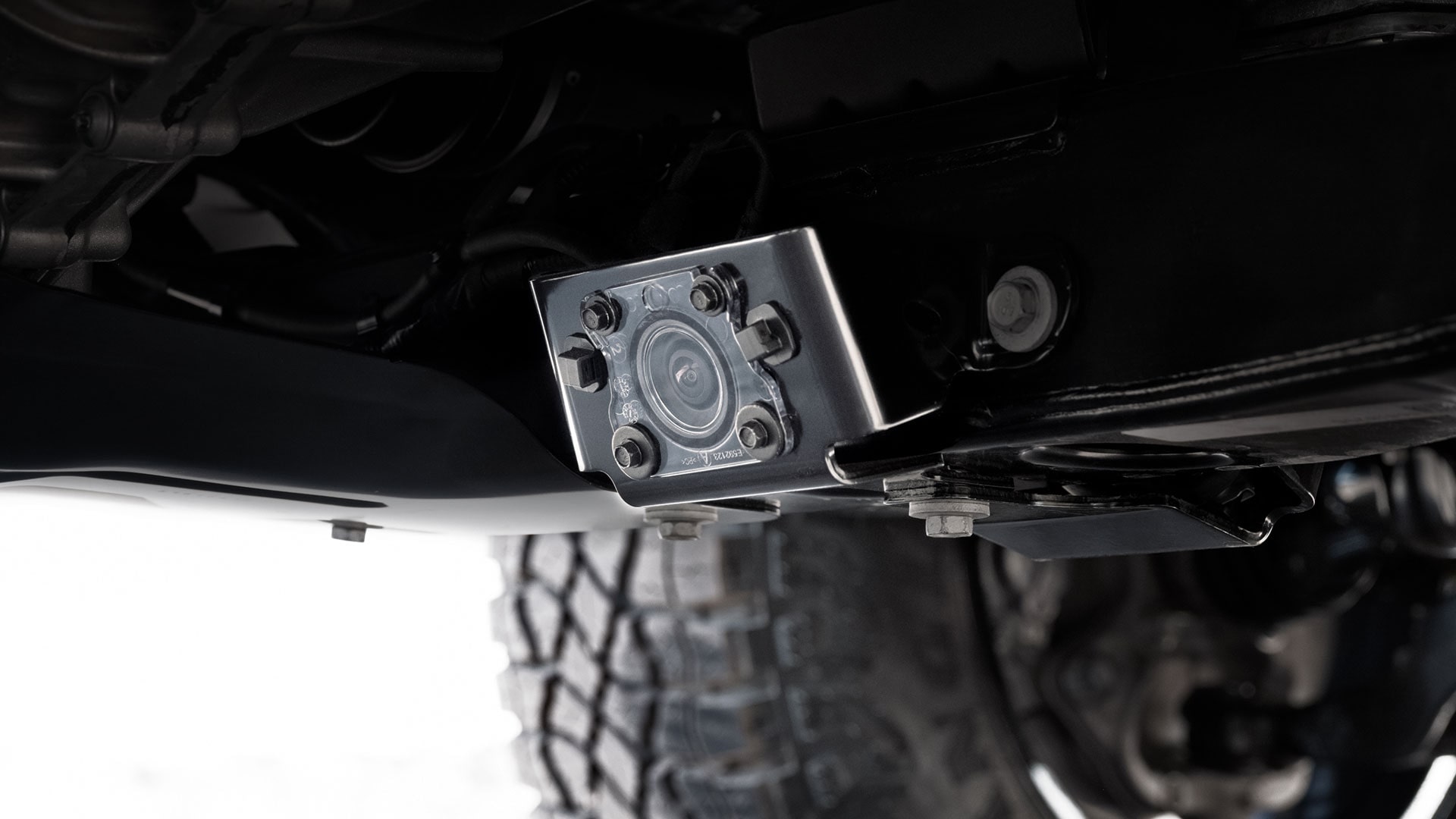 A Close-up View of an Underbody Camera Mounted on the Chassis of a GMC Canyon AT4X Truck