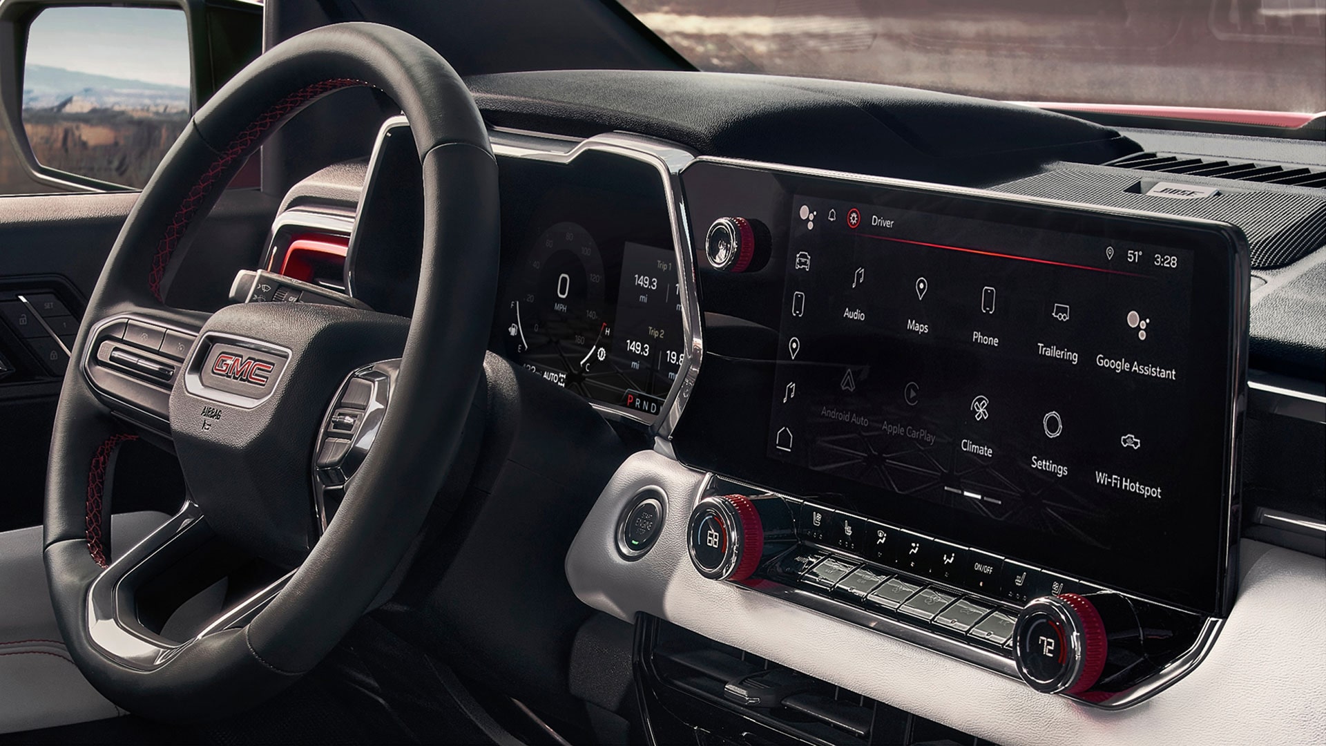 The Interior Dashboard of a GMC Canyon AT4X With a Steering Wheel Digital Cluster and Large Infotainment Touchscreen