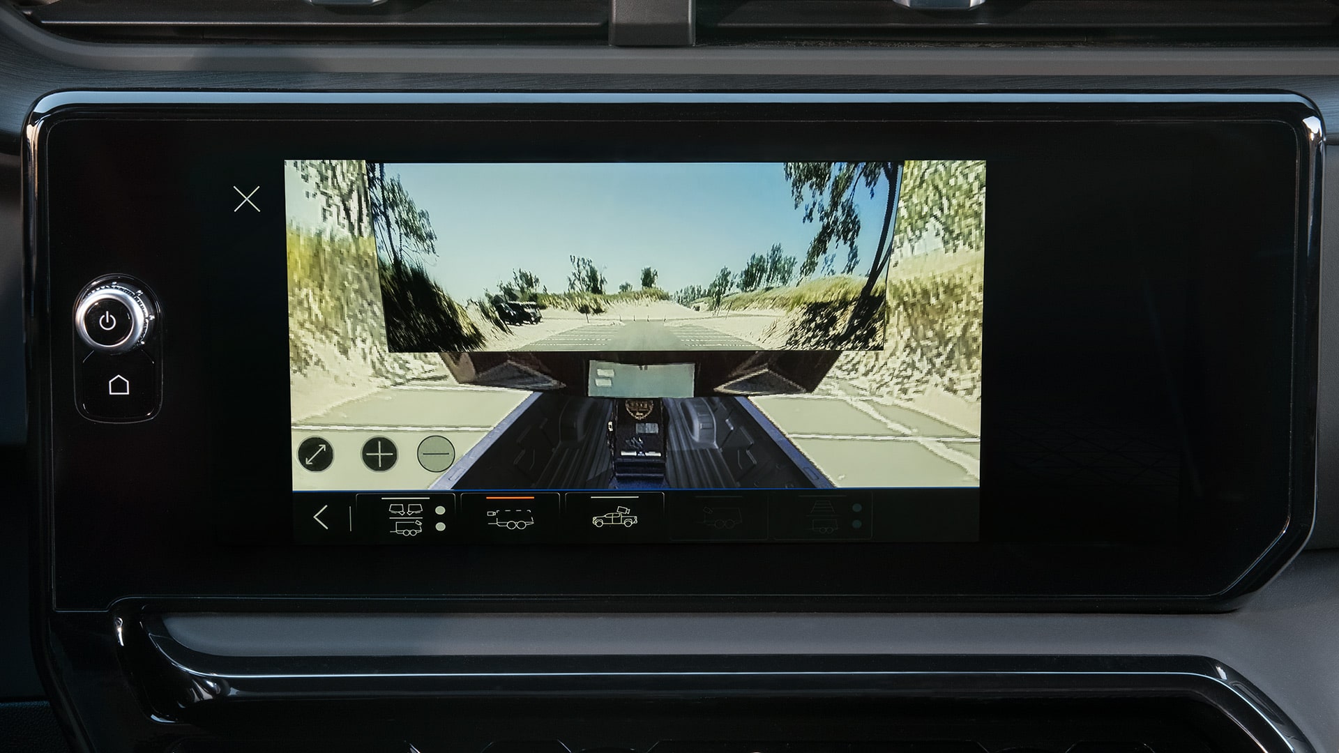 Dashboard Display Screen Showing a Rear View Camera Feed of a Truck Pulling a Trailer with Various Camera View Options