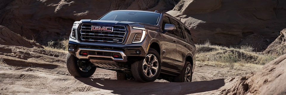 The GMC Yukon Large SUV Driving Off-Road Over Rough Terrain