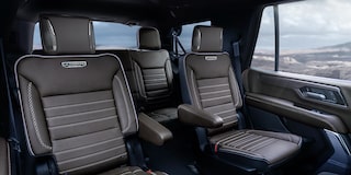 Brown Leather Interior Seats with White Stitching and Ultimate Branding in a GMC Vehicle with a Rocky Landscape Outside