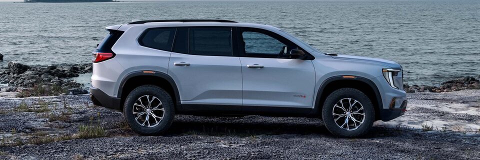 Profile View of the GMC Acadia Parked Next to a Body of Water