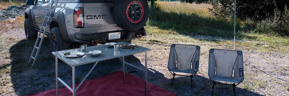 GMC Canyon AT4 in the background of a camp setting