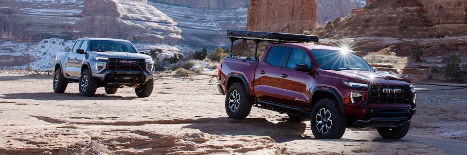Two GMC Canyon AT4X Trucks Driving Through Rocky Terrain