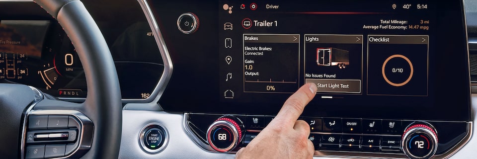 Driver Pressing the Start Light Test Option Displayed on the Infotainment System