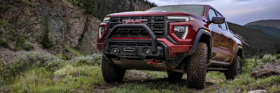 The New GMC Canyon AT4X Driving Off-Road On Grass up a Hill