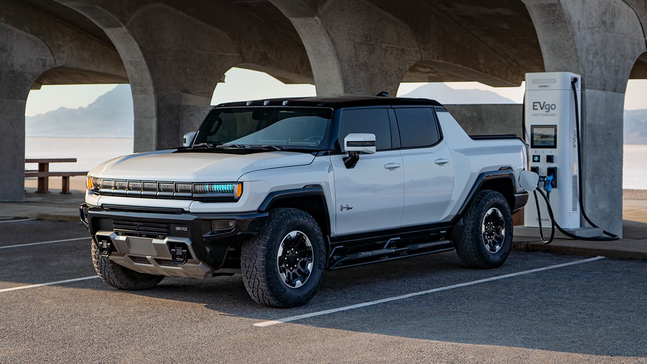 Front View of a GMC HUMMER EV Pickup Truck Using a Public Charging Station