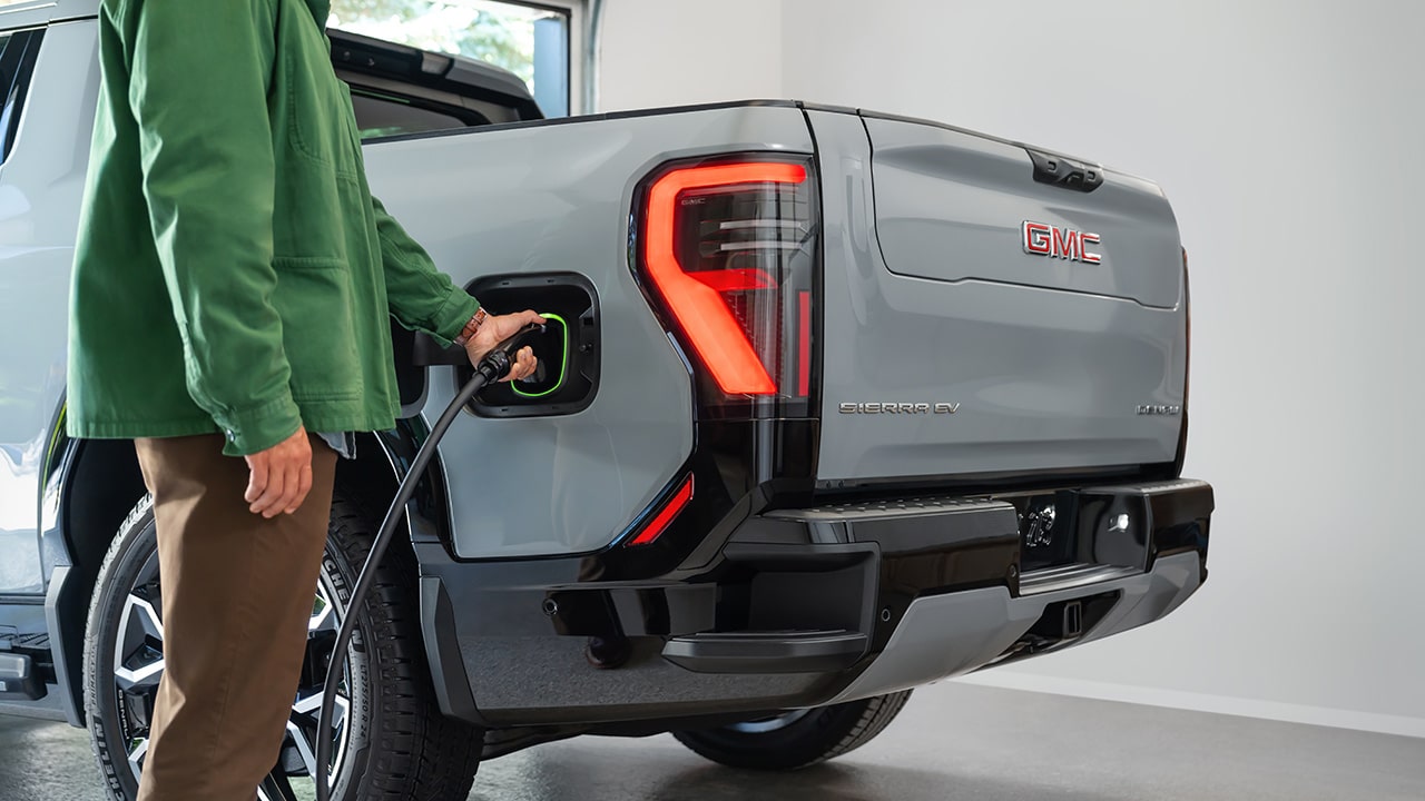 A Man Charging his Sierra EV at a Public Charging Station