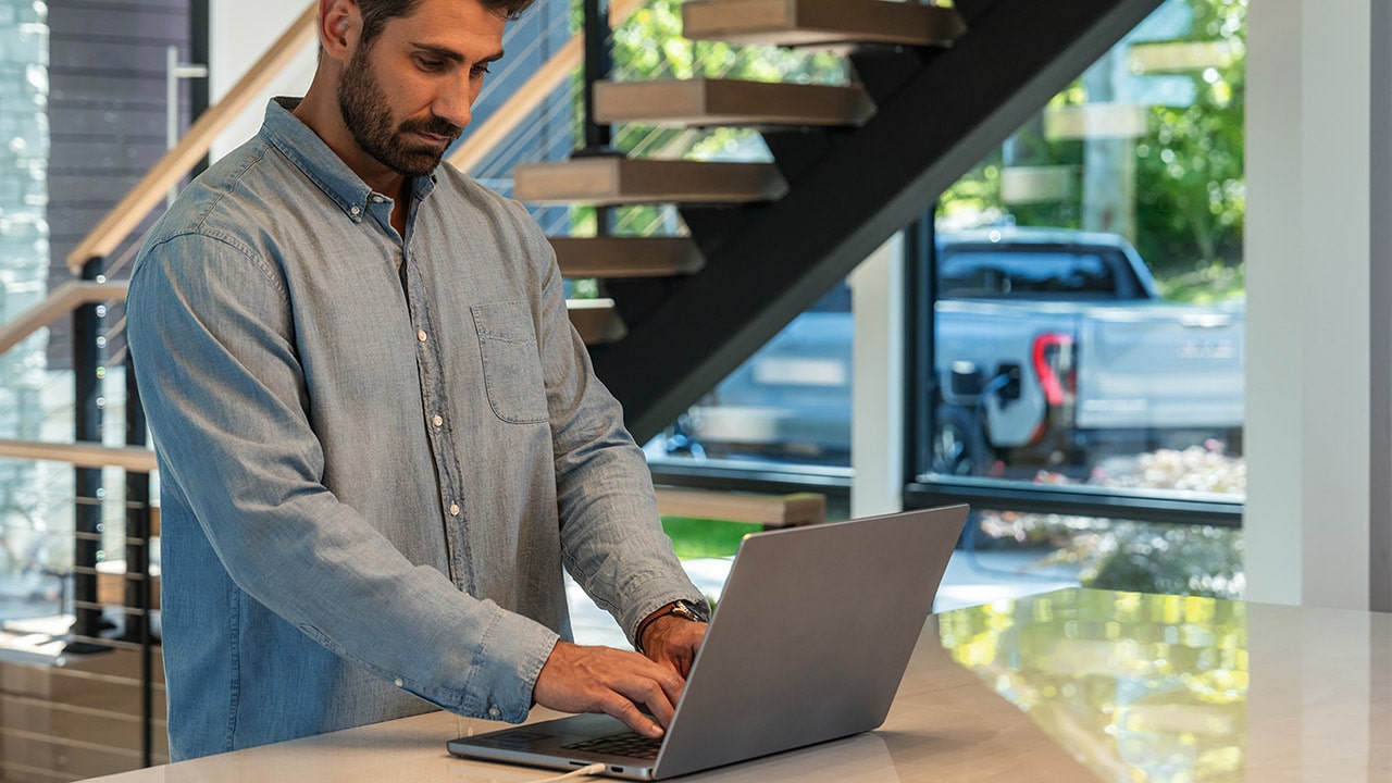 A Man Charging his Sierra EV Pickup Truck at his Home