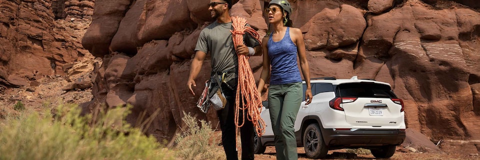 Couple Carrying Hiking Gear from their 2022 GMC Terrain AT4