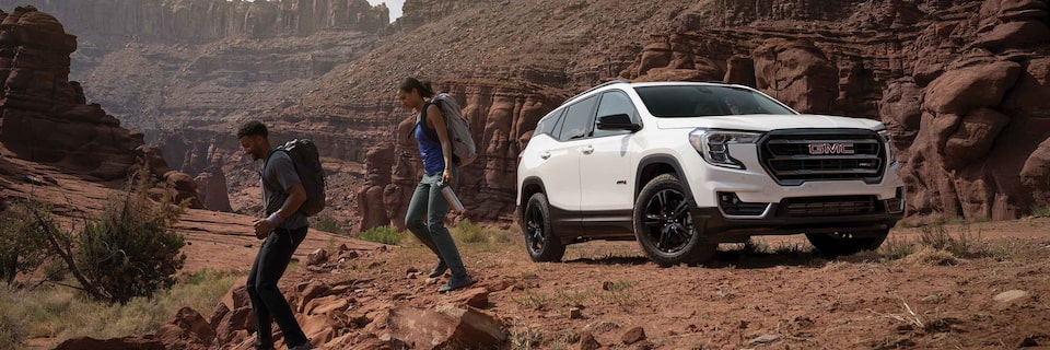 Couple Hiking in a Canyon with their 2022 GMC Terrain AT4