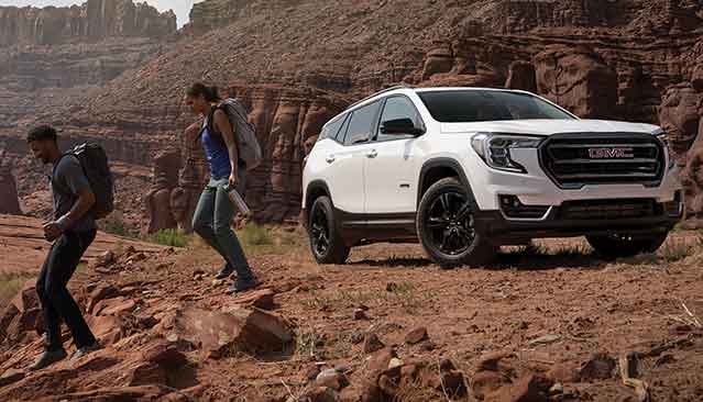 Couple Hiking in a Canyon with their 2022 GMC Terrain AT4