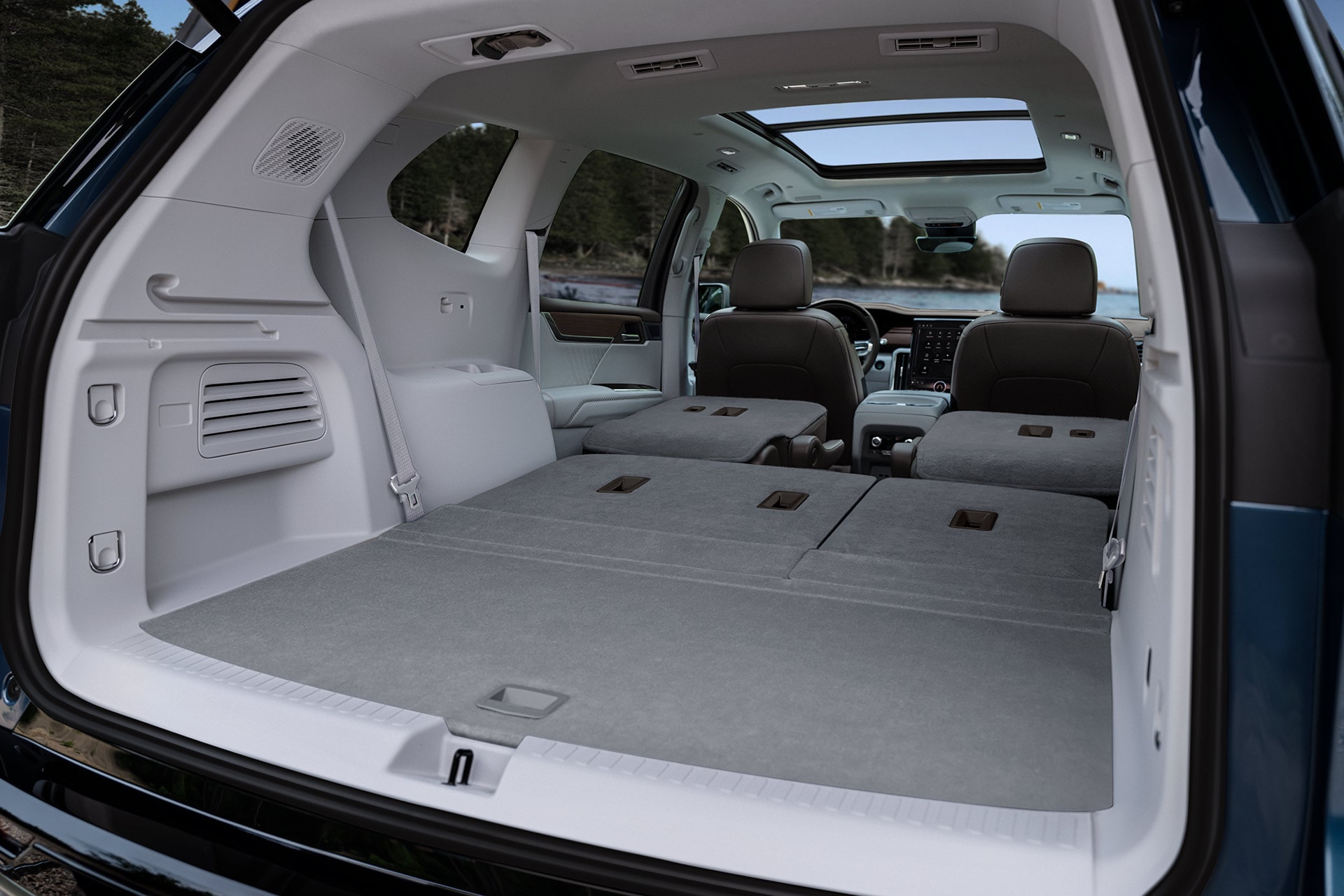 The Spacious Rear Cargo Area of a GMC SUV with the Second and Third Row Seats Folded Flat