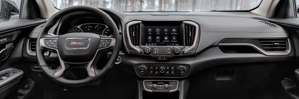 Dark-finished aluminum trim & patterned décor on the instrument panel of 2022 GMC Terrain AT4
