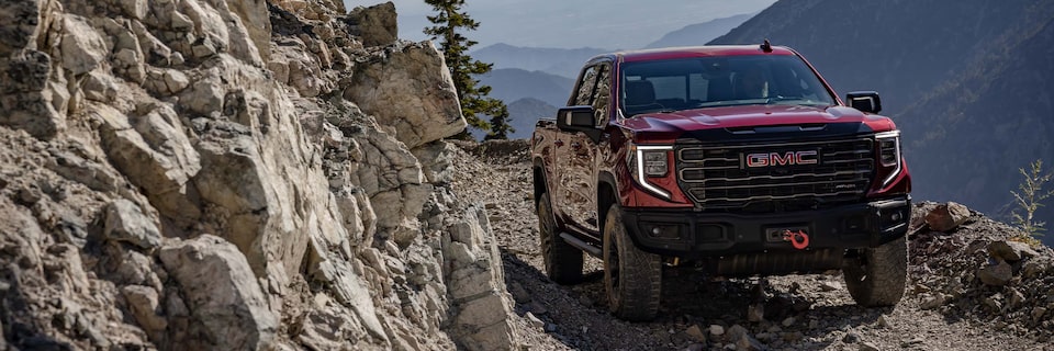 The GMC Sierra AT4X Truck Driving Off-Road Through the Mountains