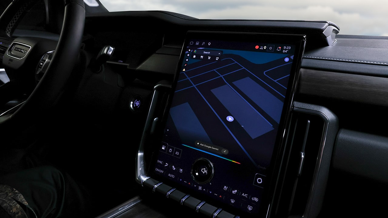 A Vehicle's Interior Showcasing a Large Infotainment Screen with Google Maps Navigation in Dark Mode