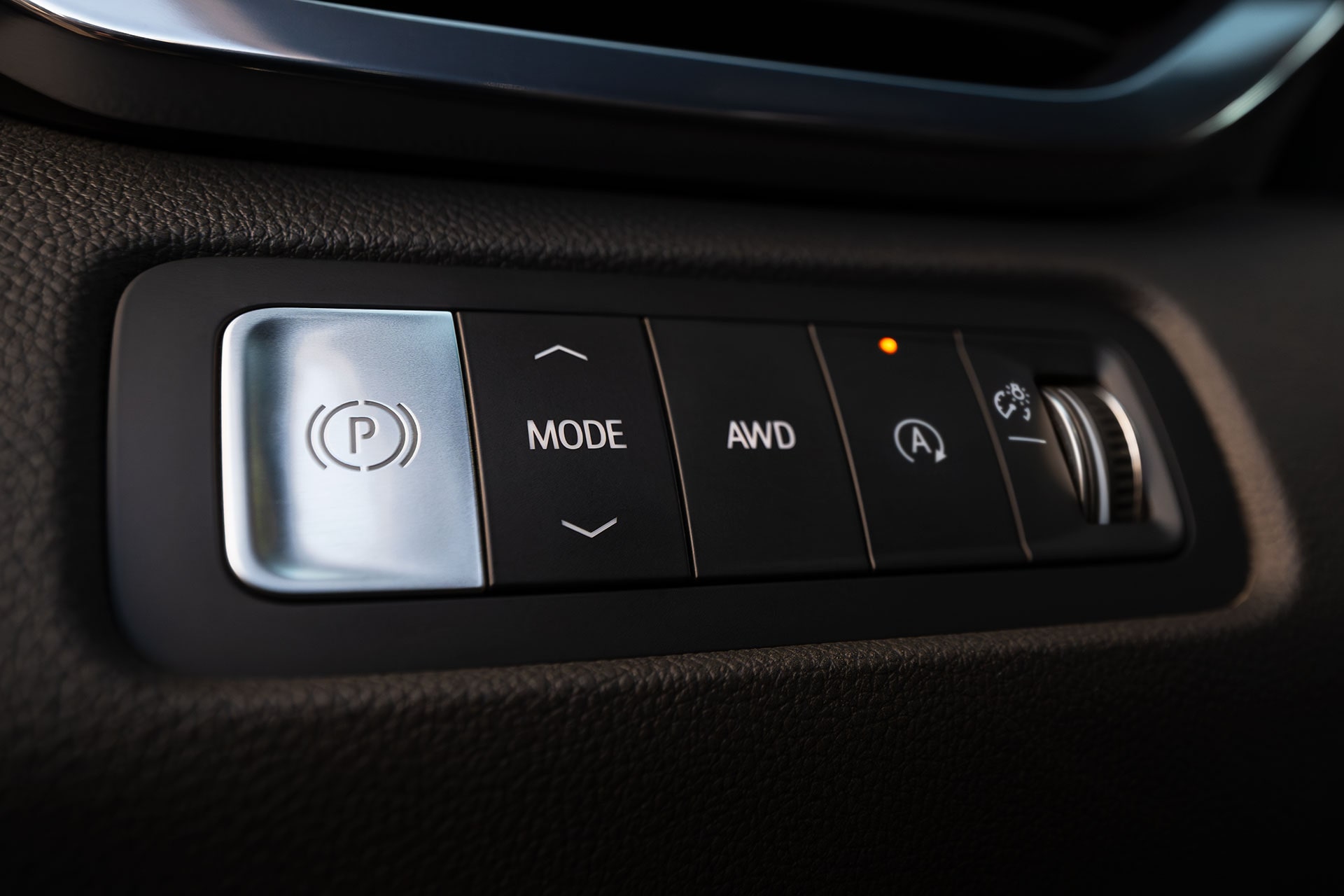 A Close-Up of the GMC Acadia Control Panel Featuring Buttons for Parking Brake, Mode, AWD, and Auto Stop-Start