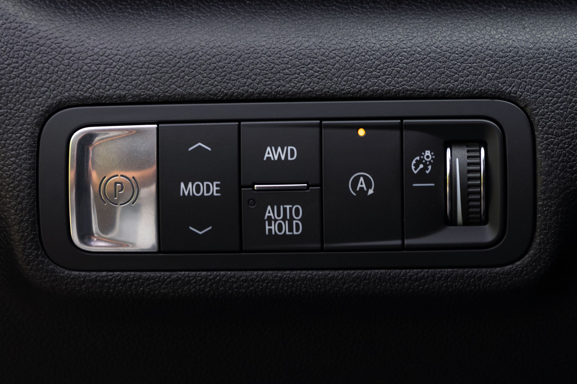 A Close-Up of the GMC Acadia Center Console Control Panel with Buttons for Parking Brake, Mode, AWD, Auto Hold, and Light Settings
