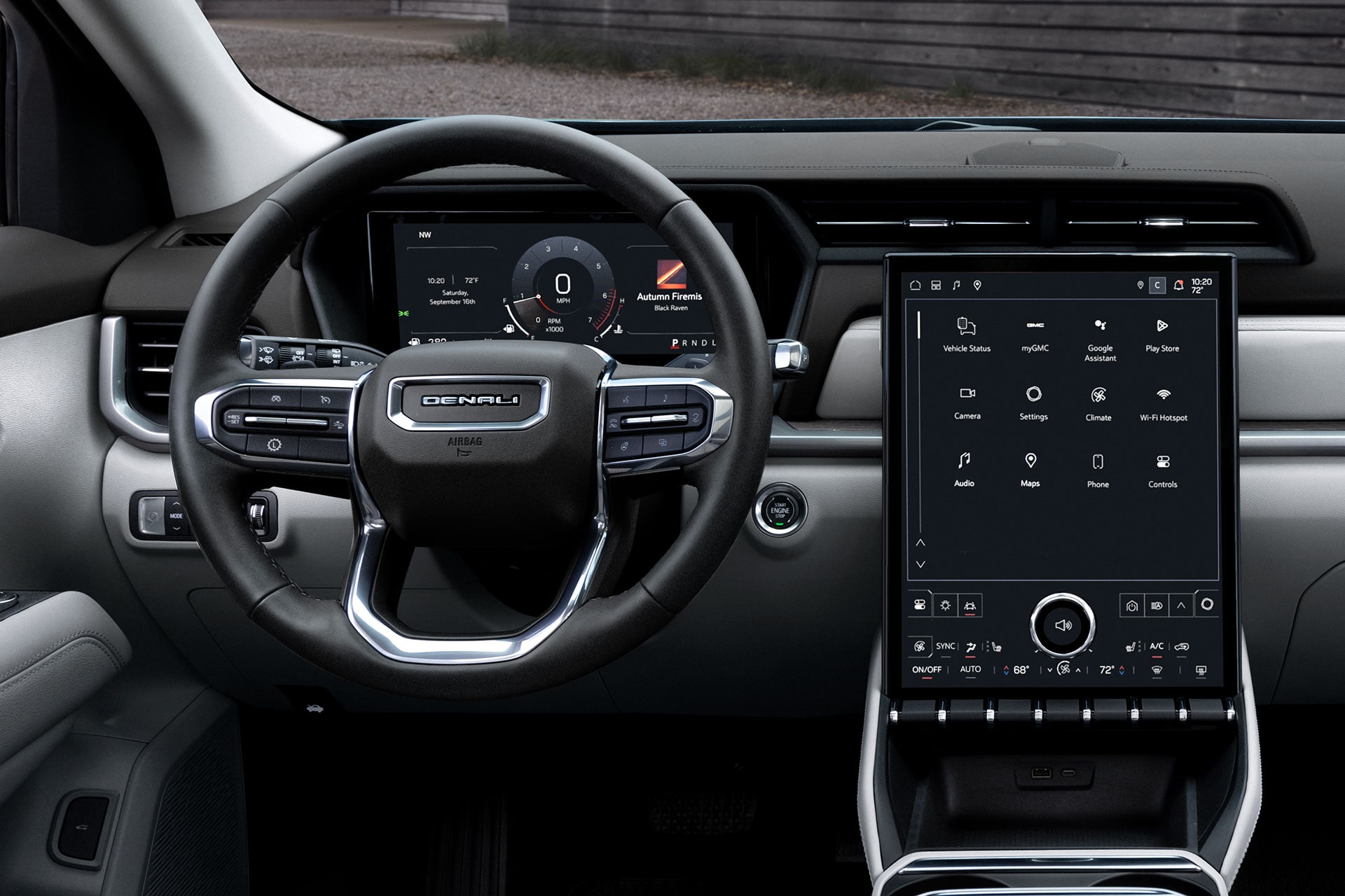 The Interior of a GMC Acadia Denali Showing the Steering Wheel, Digital Dashboard, and Large Vertical Infotainment Screen