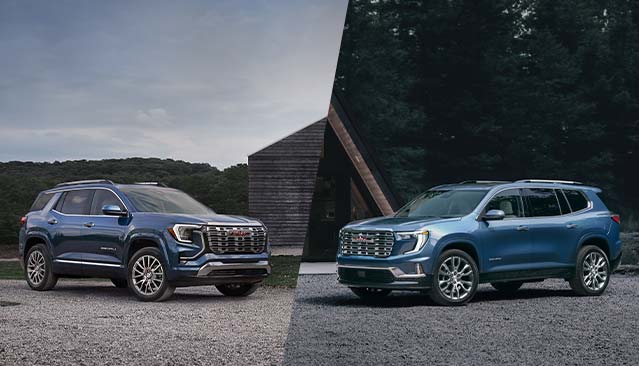  Two Blue GMC Acadia Denali SUVs, One on the Left and One on the Right, Parked on a Gravel Surface in Front of a Modern Building