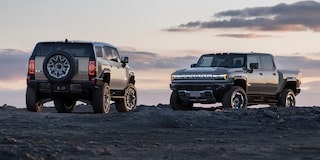 The GMC HUMMER EV SUV and The HUMMER EV Pickup Truck Parked Off-Road as the Sunsets
