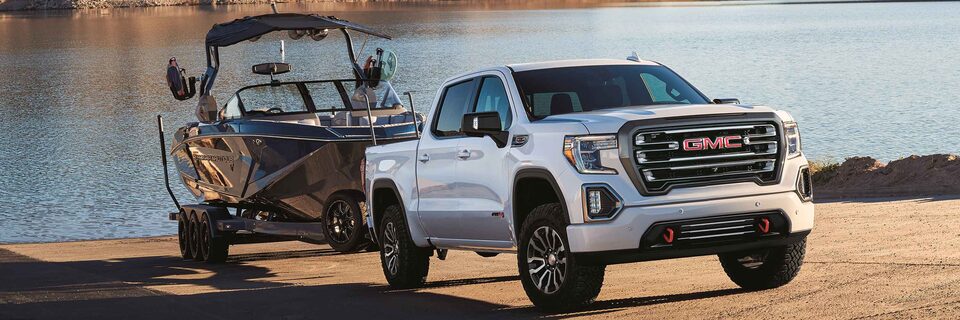 GMC Sierra 1500 AT4 off-road truck towing a Nautique Boat
