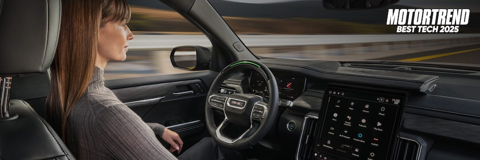 Woman Using Super Cruise in a GMC with Text Overlay: MOTORTREND BEST TECH 2025