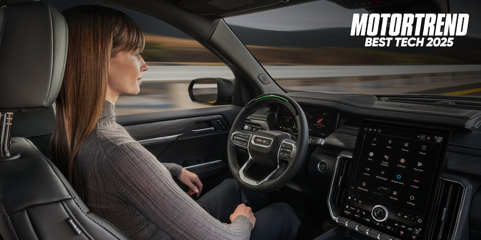 Woman Using Super Cruise in a GMC with Text Overlay: MOTORTREND BEST TECH 2025