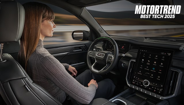 Woman Using Super Cruise in a GMC with Text Overlay: MOTORTREND BEST TECH 2025