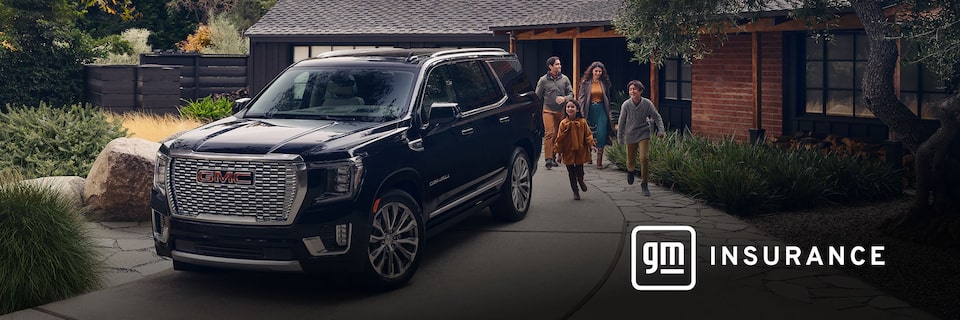 GMC Yukon Large SUV sits in the driveway while a family of four exits the house and is walking toward the vehicle. OnStar Insurance logo is in the bottom right corner of the image