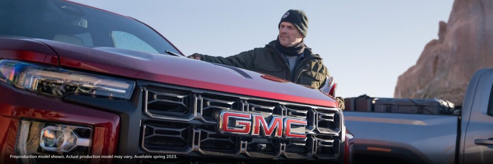 A Man Stands Alongside his GMC Canyon AT4X