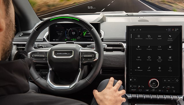 An Interior View of a GMC Denali Steering Wheel and Digital Dashboard Showing 55 MPH