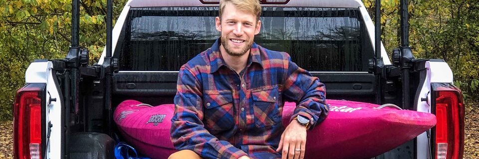 Nick Troutman sitting on bed of GMC Sierra AT4 Off-Road Truck
