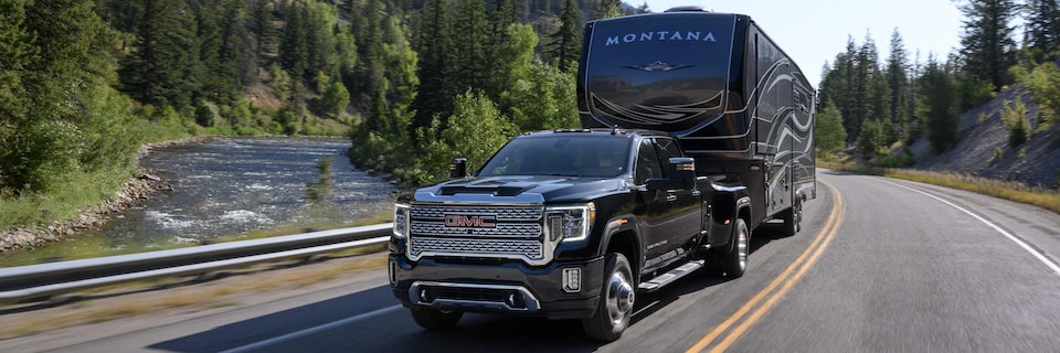 GMC Sierra Truck Towing Trailer on Mountain Road