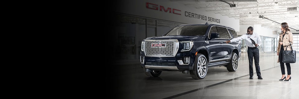 GMC Certified Service Representative Showing a Customer to Their Vehicle