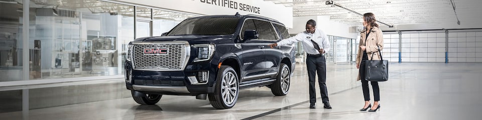 GMC Certified Service Representative Showing a Customer to Their Vehicle
