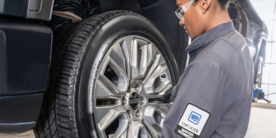 GMC Certified Service Technician Installing a Wheel on a Vehicle
