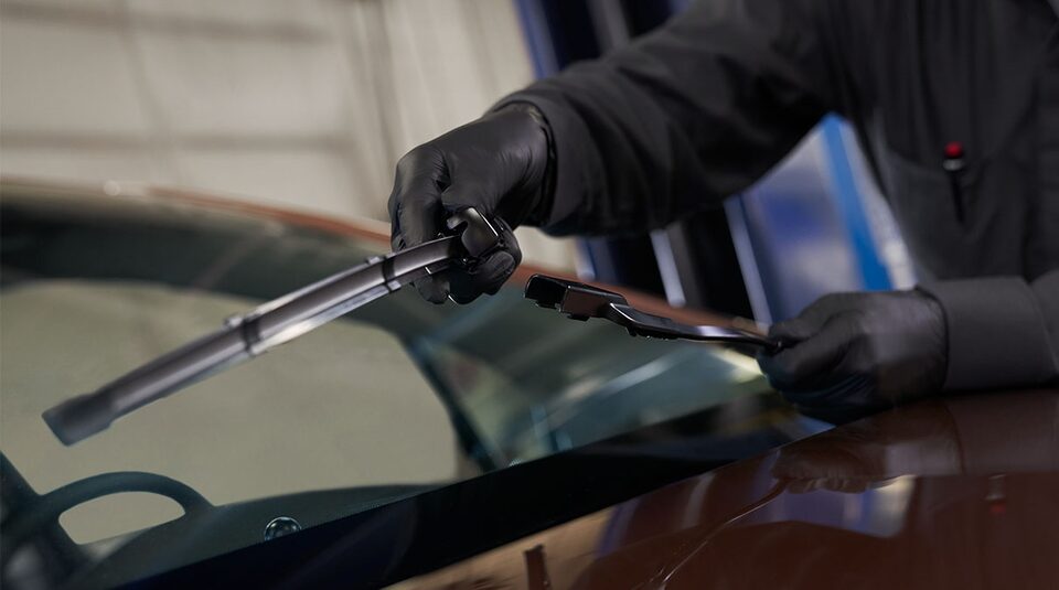 GM Technician Replacing Windshield Wipers on a Vehicle