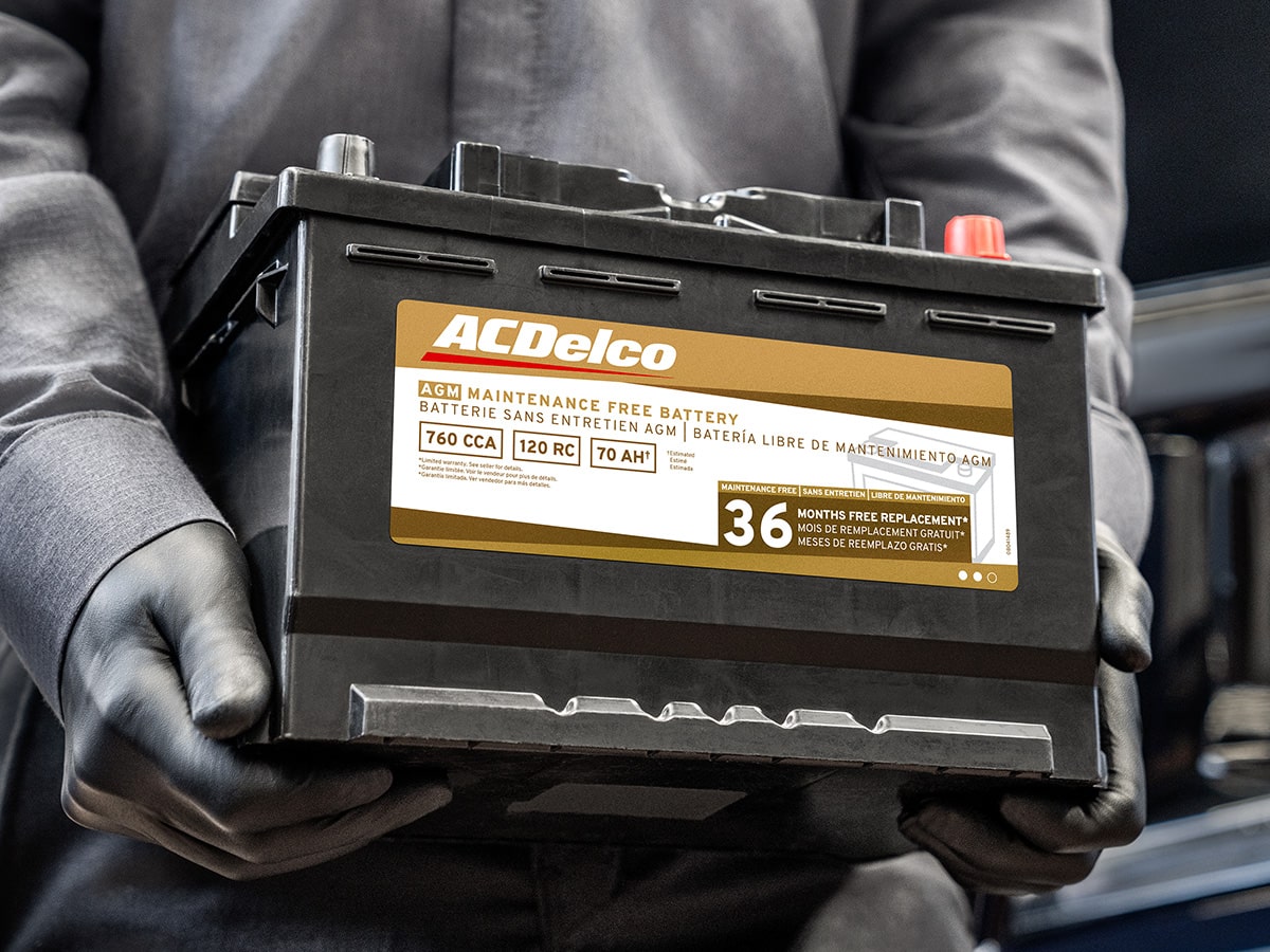 A Person Is Carrying and Walking with an Acdelco Battery