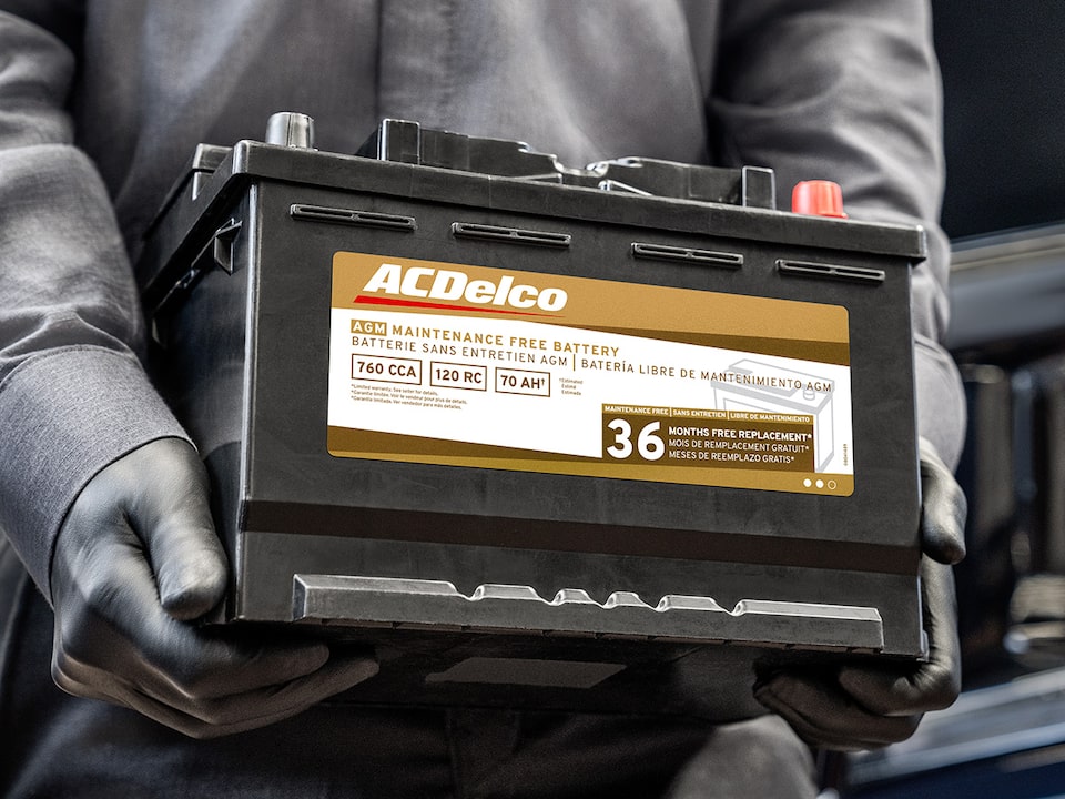 A Person Is Carrying and Walking with an Acdelco Battery