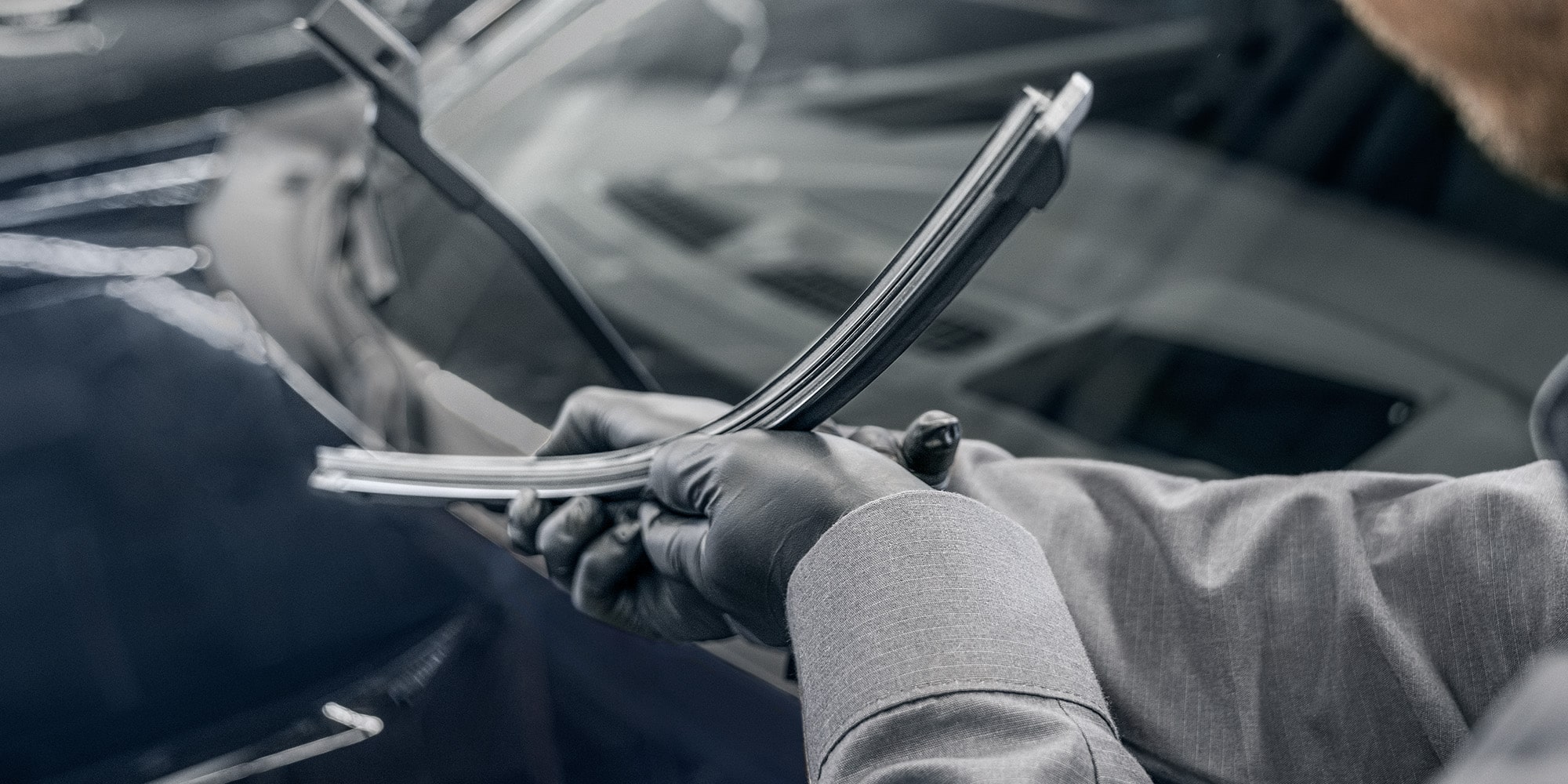 A Mechanic Wearing Safety Glasses Inspecting the Break of a Wheel inside a Vehicle