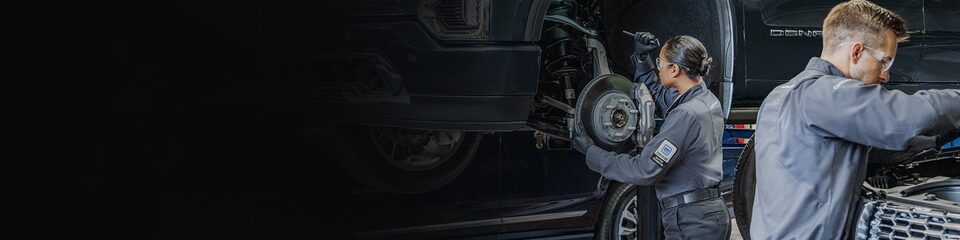 GMC Certified Service Technician holding an ACDelco Car Battery