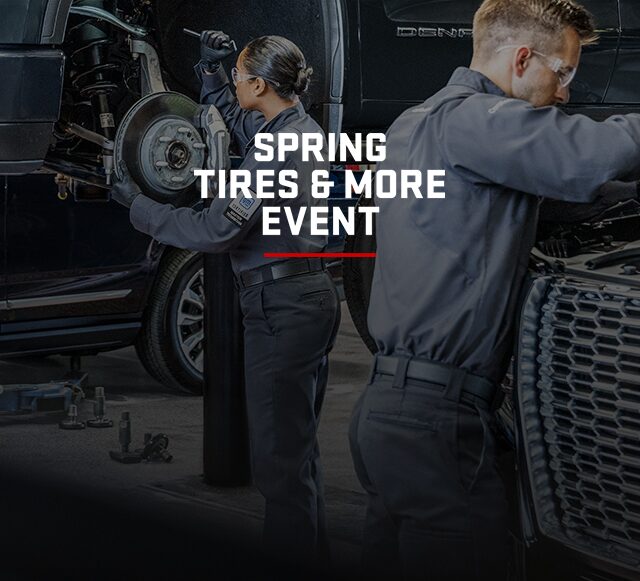 GMC Certified Service Technician holding an ACDelco Car Battery